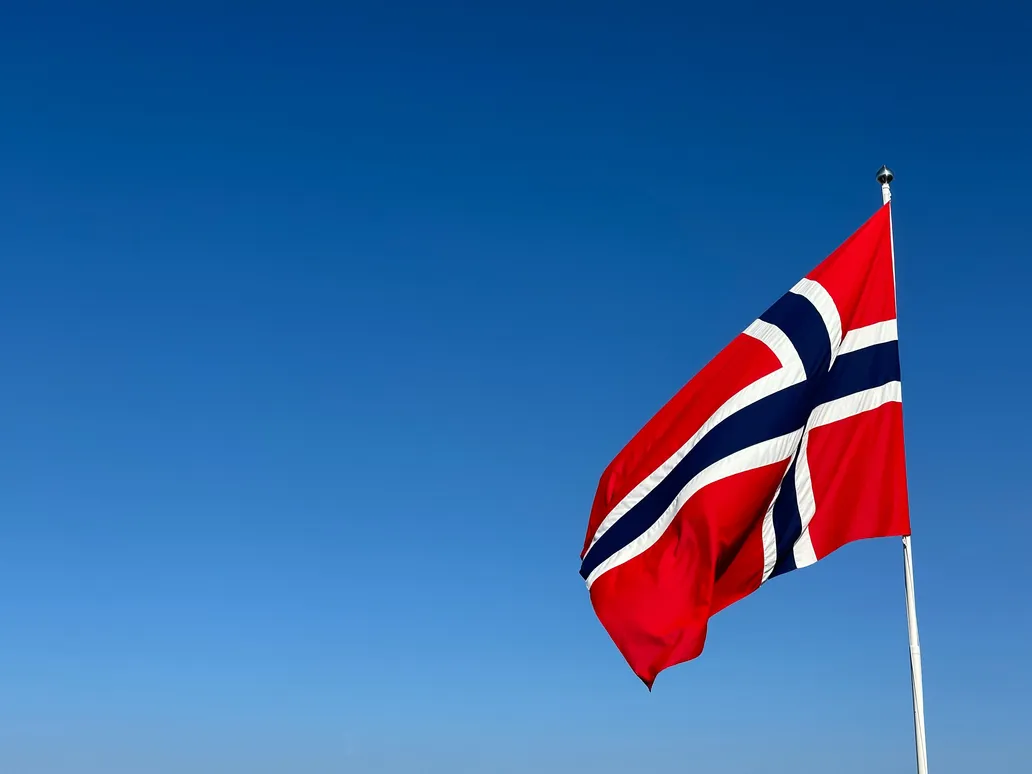 The Norwegian flag against a clear sky